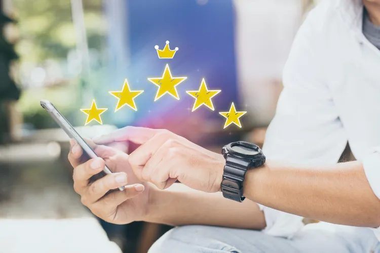 Three colleagues reviewing dashboard metrics on a laptop in an office — the ROI case for reviews is measurable, and the cleanup side compounds the upside